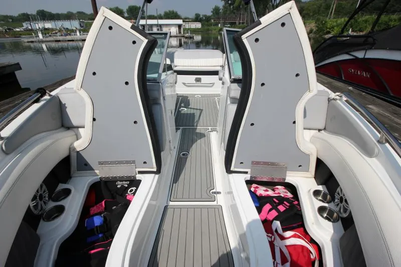 Slide: The Image of 2015 Cruisers Sport Series 238 Bow Rider interior with open storage compartments and seating. - 24