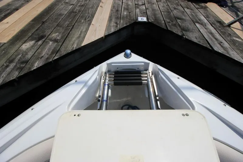 Slide: The Image of 2015 Cruisers Sport Series 238 Bow Rider at dock, showing bow ladder and deck. - 26