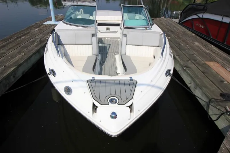 Slide: The Image of 2015 Cruisers Sport Series 238 Bow Rider docked, showcasing sleek design and spacious seating. - 5
