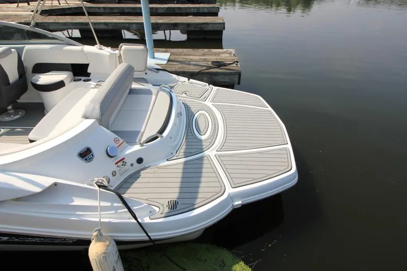 Slide: The Image of 2015 Cruisers Sport Series 238 Bow Rider at dock, featuring spacious swim platform. - 7