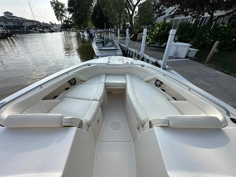 Slide: The Image of 2024 Grady-White Freedom 335 boat with spacious seating at a dock. - 12