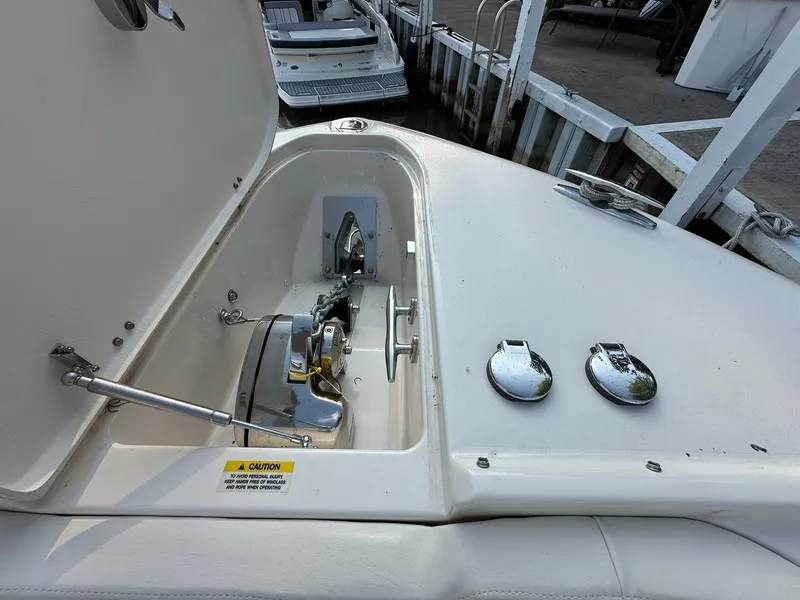 Slide: The Image of 2024 Grady-White Freedom 335 boat anchor compartment with open hatch at dock. - 14
