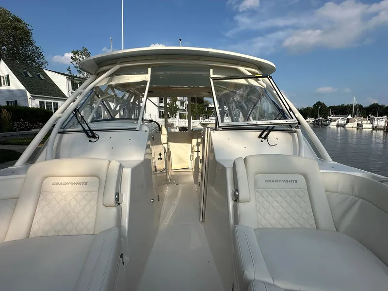 Slide: The Image of 2024 Grady-White Freedom 335 boat interior with luxurious seating and clear skies. - 15