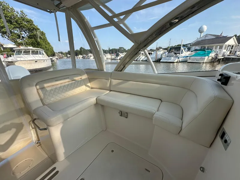 Slide: The Image of 2024 Grady-White Freedom 335 boat interior with luxurious seating at marina. - 18