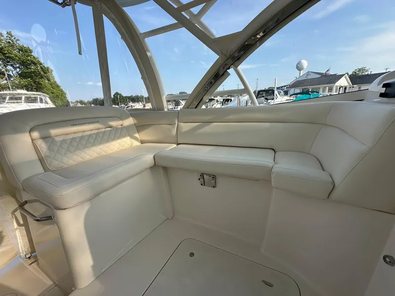 Slide: The Image of 2024 Grady-White Freedom 335 boat interior with luxurious seating and panoramic windows. - 19
