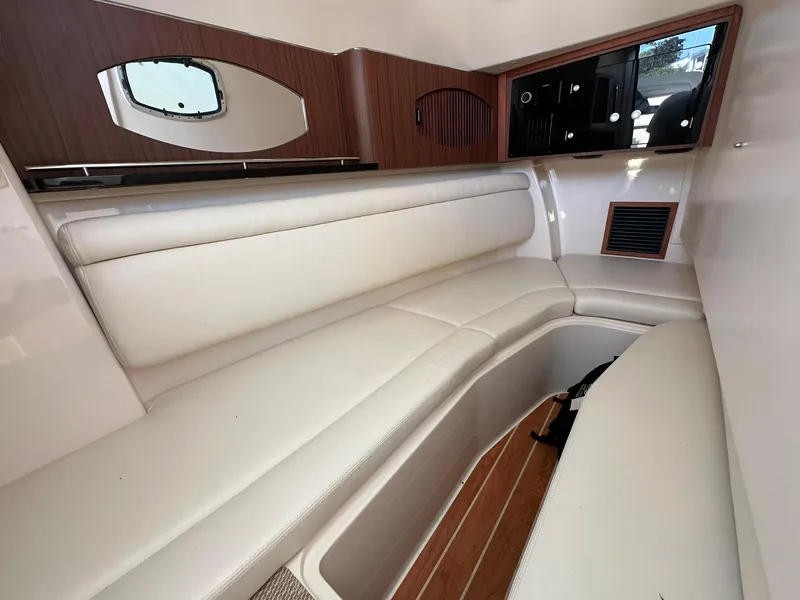 Slide: The Image of 2024 Grady-White Freedom 335 cabin interior with white seating and wood accents. - 22