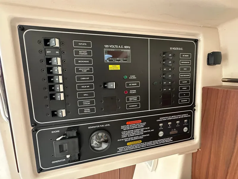 Slide: The Image of Electrical control panel on 2024 Grady-White Freedom 335 boat, featuring switches and gauges. - 24