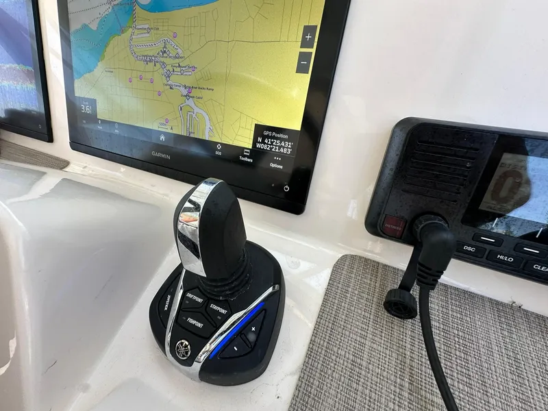 Slide: The Image of 2024 Grady-White Freedom 335 boat dashboard with Garmin navigation and joystick controls. - 28