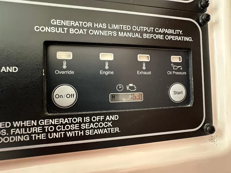 Slide: The Image of Control panel of 2024 Grady-White Freedom 335 boat generator with limited output capability warning. - 32