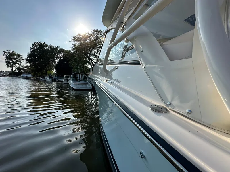 Slide: The Image of 2024 Grady-White Freedom 335 boat docked on a sunny day by the water. - 4