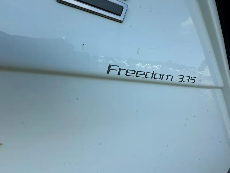 Slide: The Image of 2024 Grady-White Freedom 335 boat nameplate on white hull. - 5