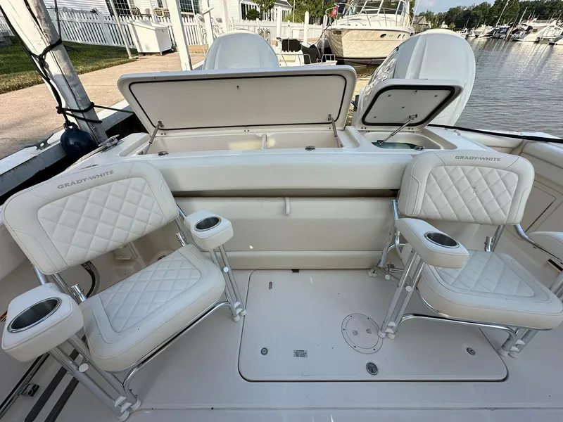 Slide: The Image of 2024 Grady-White Freedom 335 boat interior with cushioned seating and storage compartments. - 7