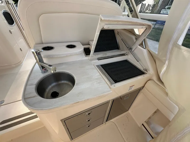 Slide: The Image of 2024 Grady-White Freedom 335 boat interior with sink and grill station. - 8