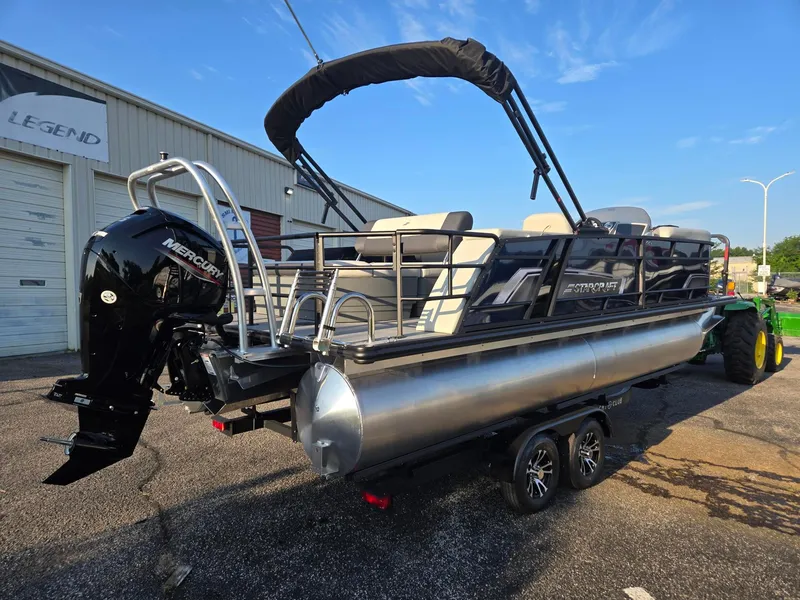 Slide: The Image of 2026 Starcraft EX22QDH pontoon boat with Mercury engine, parked outdoors. - 4