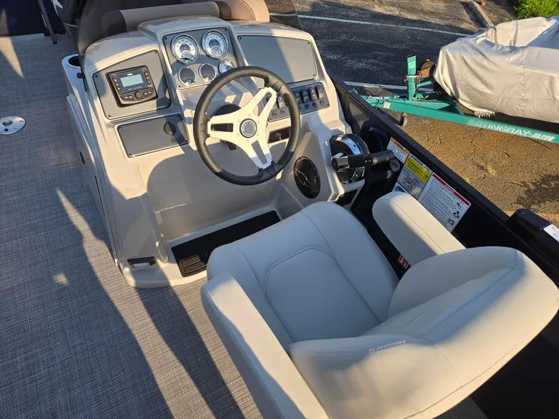 Slide: The Image of 2026 Starcraft EX22QDH boat dashboard with steering wheel and control panel. - 7