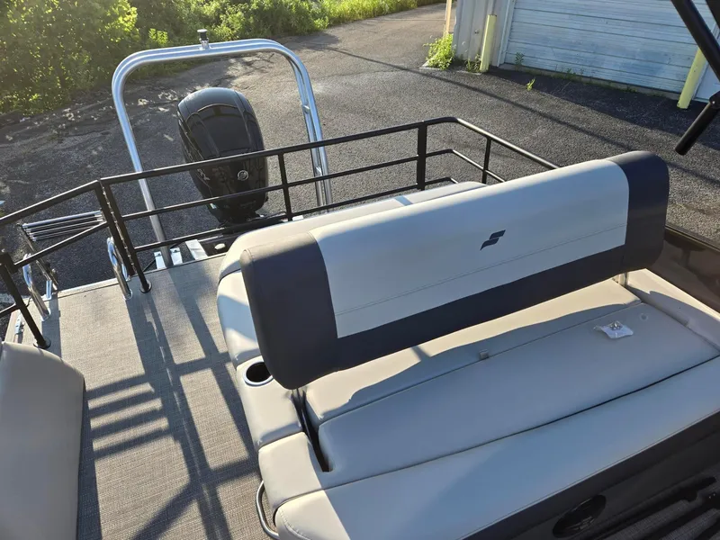 Slide: The Image of 2026 Starcraft EX22QDH boat with rear seating and outboard motor in a sunny setting. - 8