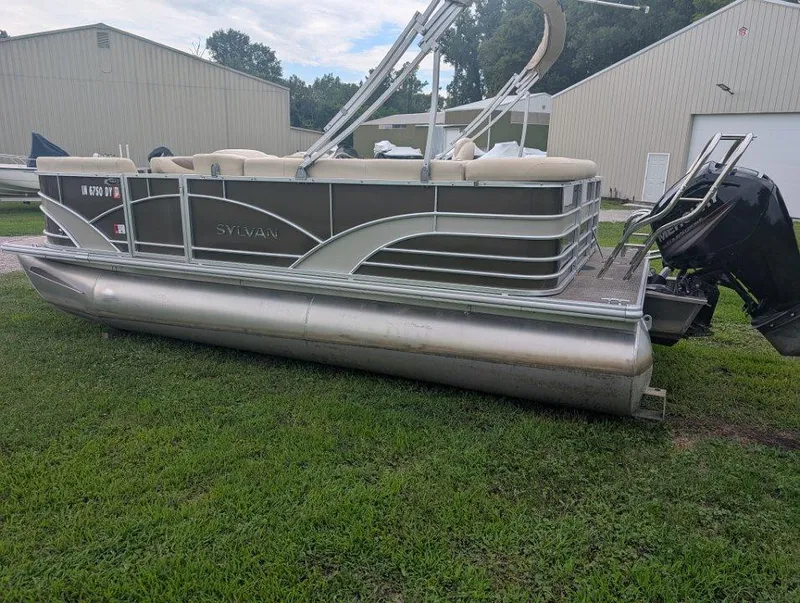 Slide: The Image of 2017 Sylvan Mirage Cruise 8520 CR pontoon boat on grass near storage buildings. - 1