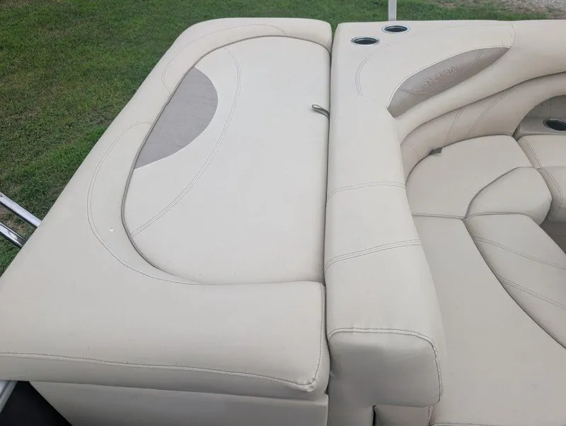 Slide: The Image of 2017 Sylvan Mirage Cruise 8520 CR boat interior with beige seating and cup holders. - 5