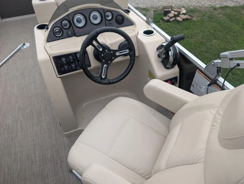Slide: The Image of 2017 Sylvan Mirage Cruise 8520 CR boat helm with steering wheel and control panel. - 6