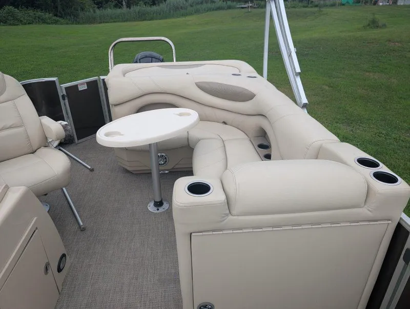 Slide: The Image of 2017 Sylvan Mirage Cruise 8520 CR pontoon boat interior with beige seating and table. - 9