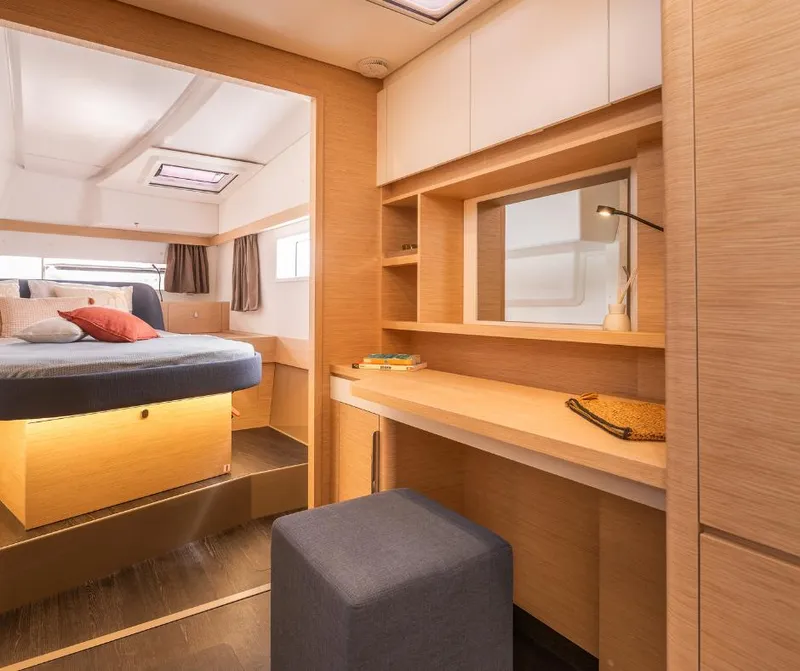 Slide: The Image of Luxurious interior of 2025 Fountaine Pajot NEW 41 catamaran, featuring a cozy bedroom and desk area. - 18