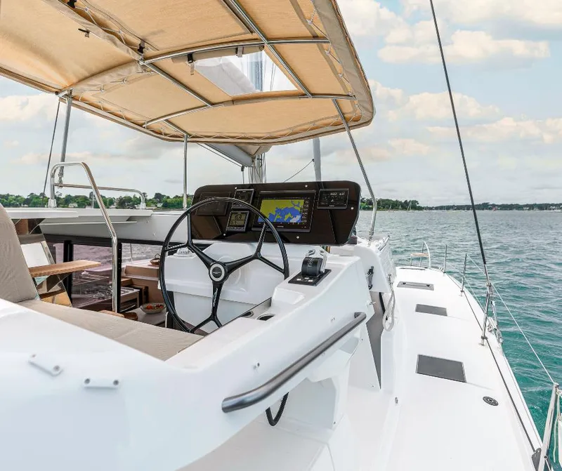 Slide: The Image of 2025 Fountaine Pajot NEW 41 yacht helm with navigation system, sailing on calm waters. - 5
