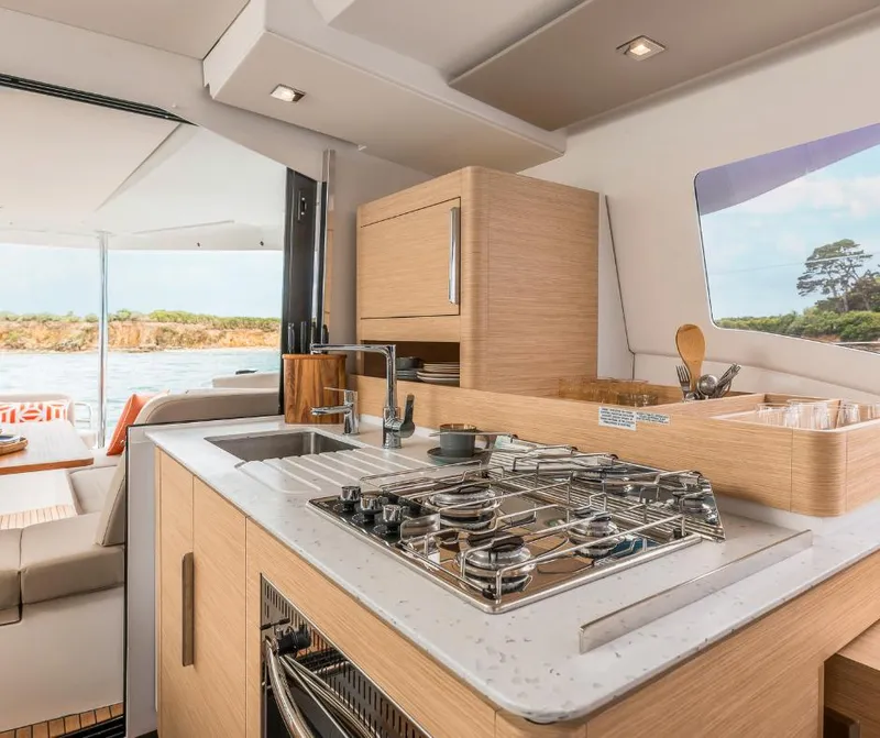 Slide: The Image of Modern kitchen interior on 2025 Fountaine Pajot NEW 41 yacht, featuring sleek design and appliances. - 6