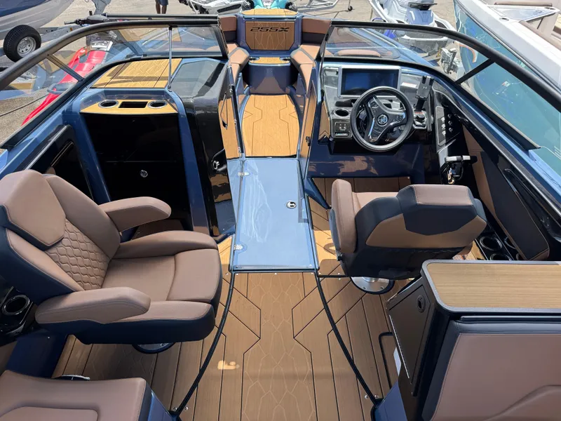 Slide: The Image of 2024 Yamaha Boats 255XD interior with luxurious seating and modern dashboard design. - 12