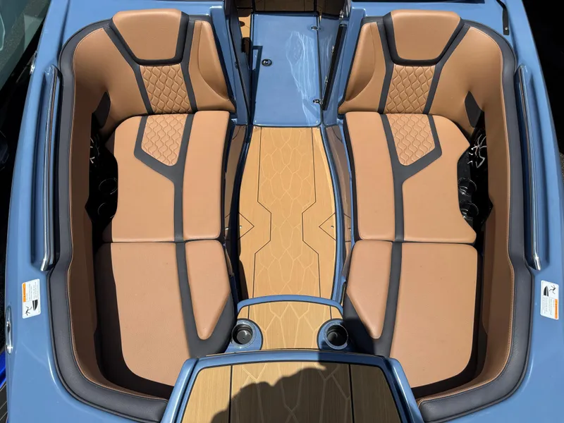 Slide: The Image of 2024 Yamaha Boats 255XD interior with tan seating and blue accents. - 15