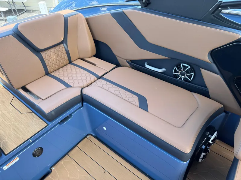 Slide: The Image of 2024 Yamaha Boats 255XD interior seating with tan and blue upholstery. - 20