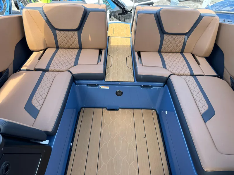 Slide: The Image of 2024 Yamaha Boats 255XD interior with tan and blue seating, showcasing modern design. - 21