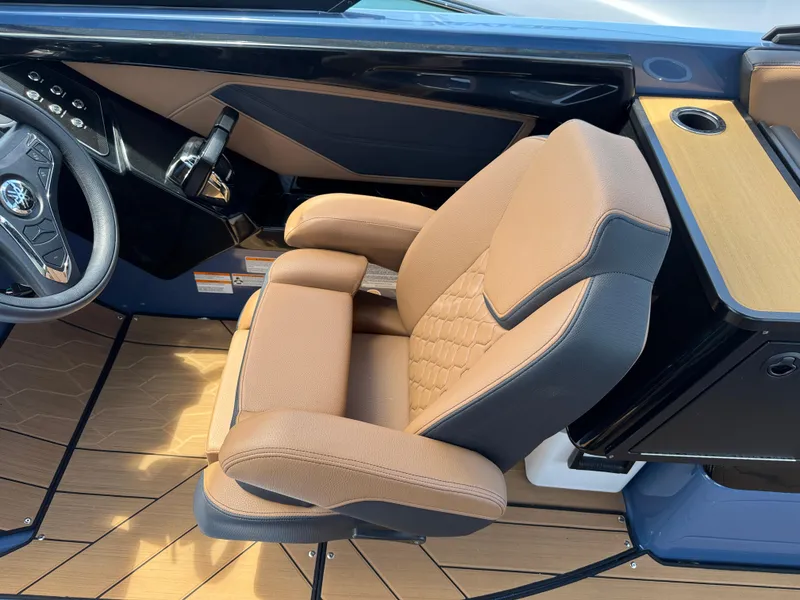 Slide: The Image of 2024 Yamaha Boats 255XD cockpit with tan seating and modern steering wheel design. - 23