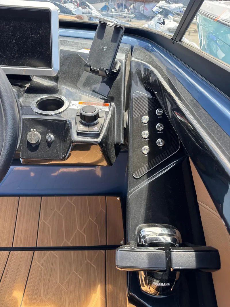 Slide: The Image of 2024 Yamaha Boats 255XD dashboard with controls and display screen. - 25