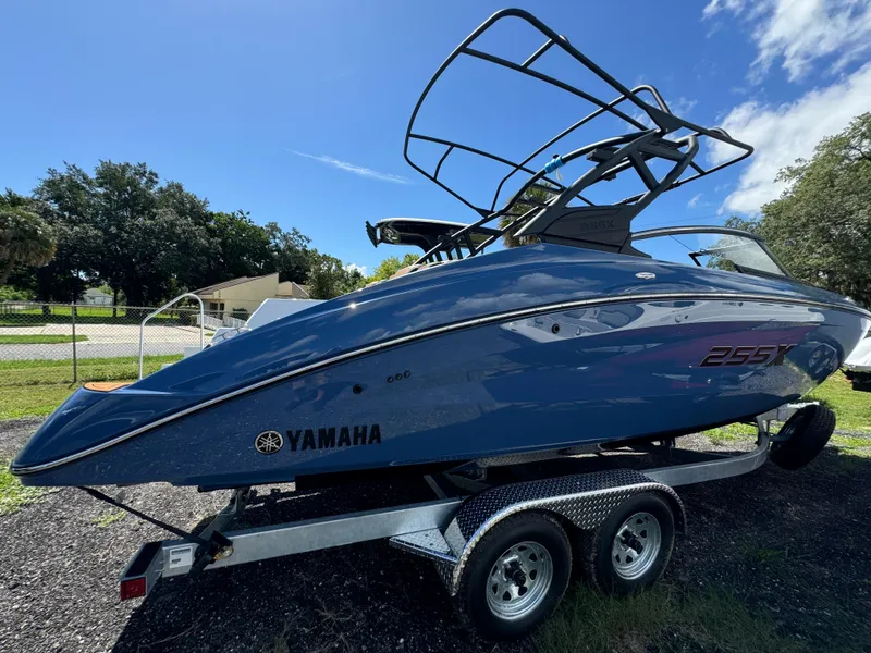 Slide: The Image of 2024 Yamaha Boats 255XD on trailer, sleek design under clear blue sky. - 4