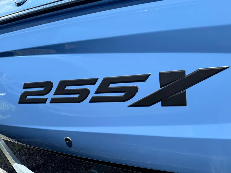 Slide: The Image of Close-up of 2024 Yamaha Boats 255XD model emblem on blue hull. - 7