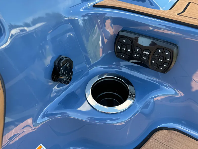 Slide: The Image of 2024 Yamaha Boats 255XD control panel with cup holder and audio controls. - 8