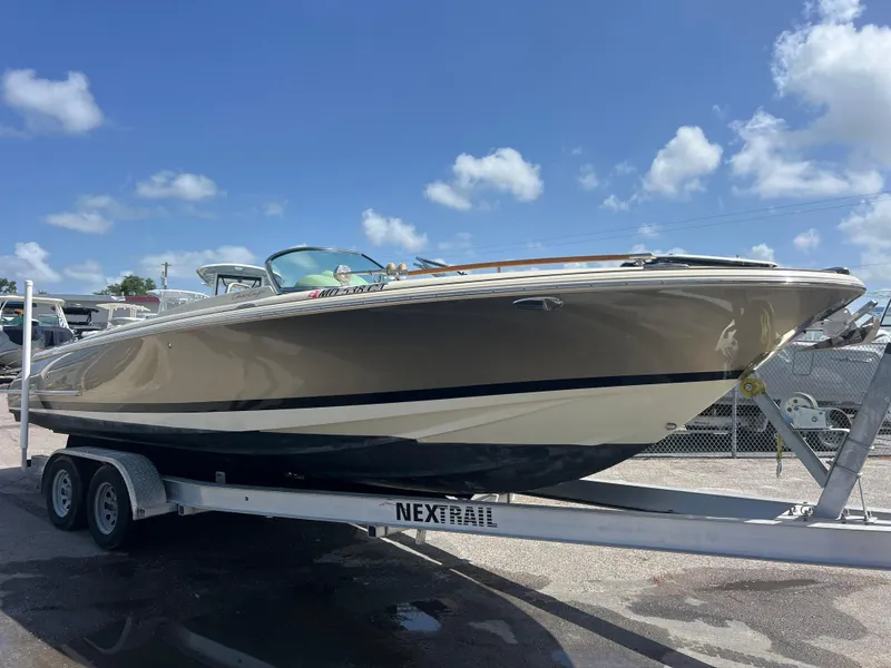 The Image of 2019 Chris-Craft Corsair 27 boat on trailer under clear blue sky. - 0
