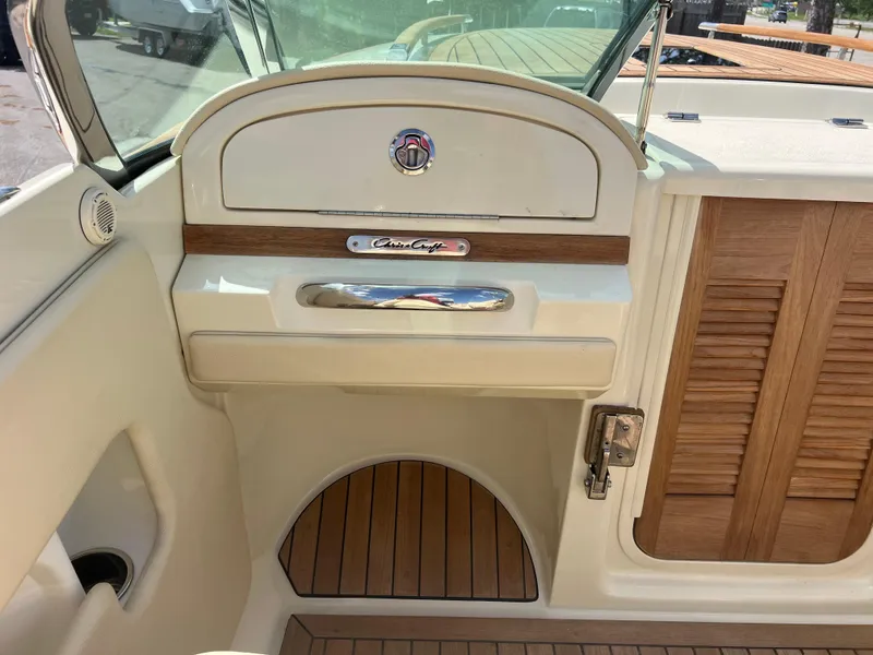 Slide: The Image of 2019 Chris-Craft Corsair 27 interior with wood accents and elegant design. - 12