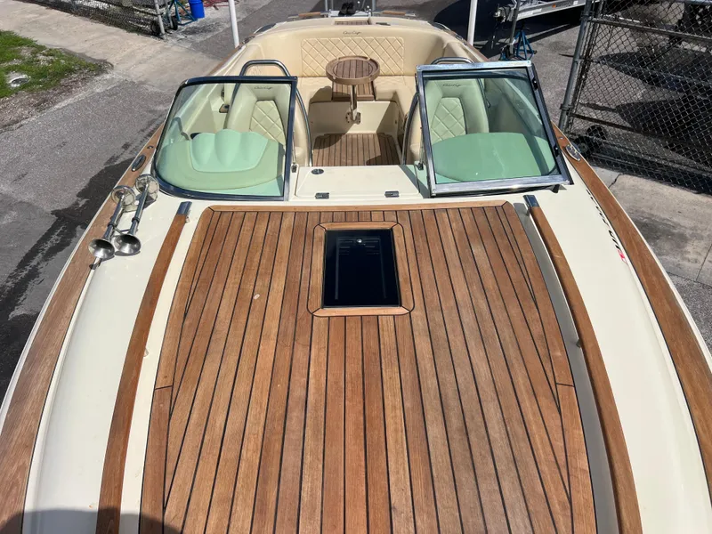 Slide: The Image of 2019 Chris-Craft Corsair 27 boat with elegant wood deck and luxurious seating. - 14