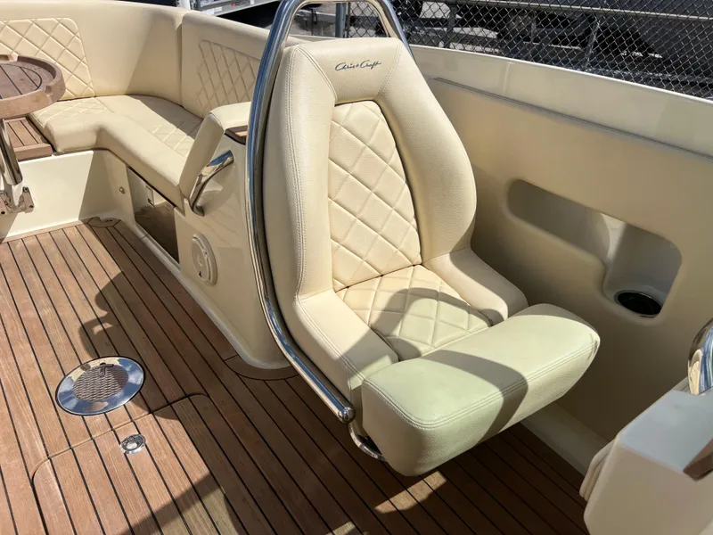 Slide: The Image of Luxurious seating on 2019 Chris-Craft Corsair 27 boat with elegant upholstery and teak flooring. - 16