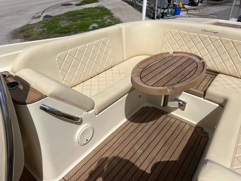 Slide: The Image of Luxurious 2019 Chris-Craft Corsair 27 boat interior with elegant seating and wooden table. - 19