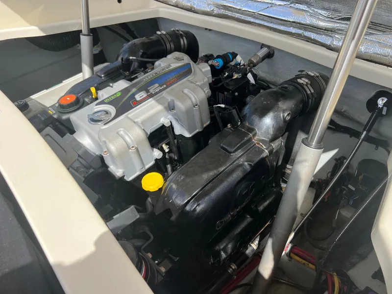 Slide: The Image of Engine compartment of a 2019 Chris-Craft Corsair 27 boat, showcasing detailed mechanics. - 21