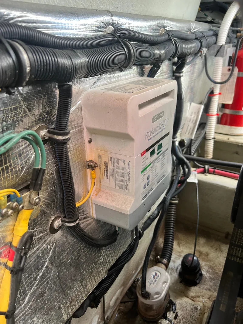 Slide: The Image of Engine compartment of 2019 Chris-Craft Corsair 27 with electrical wiring and components. - 22