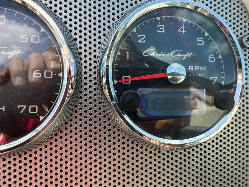 Slide: The Image of Close-up of 2019 Chris-Craft Corsair 27 dashboard gauges showing RPM and engine hours. - 23