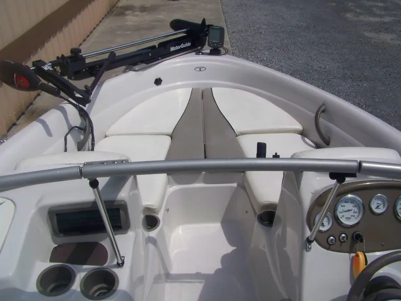 Slide: The Image of 2004 Tracker Q4 boat interior with steering wheel, gauges, and seating. - 3