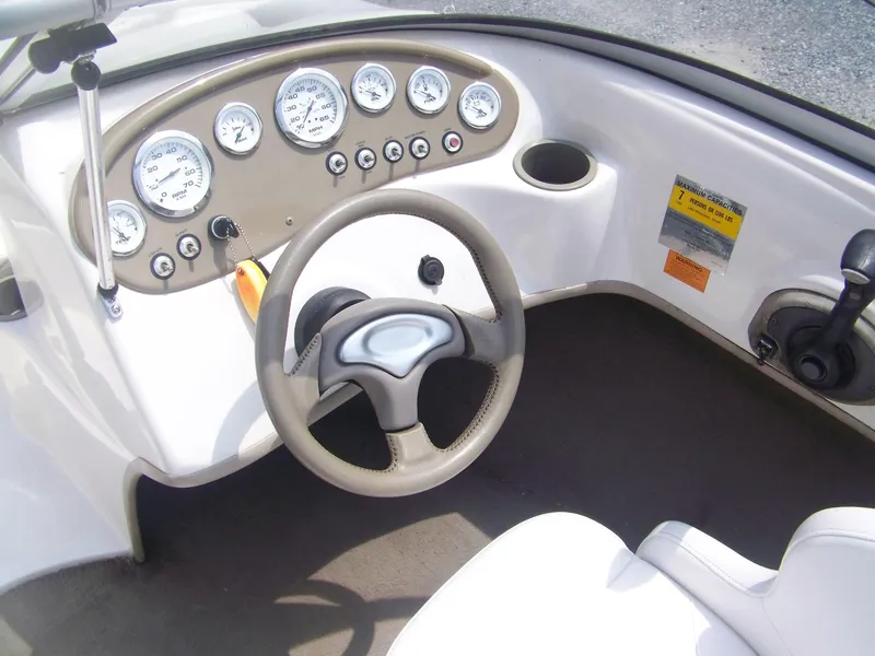 Slide: The Image of 2004 Tracker Q4 boat dashboard with steering wheel and gauges. - 4