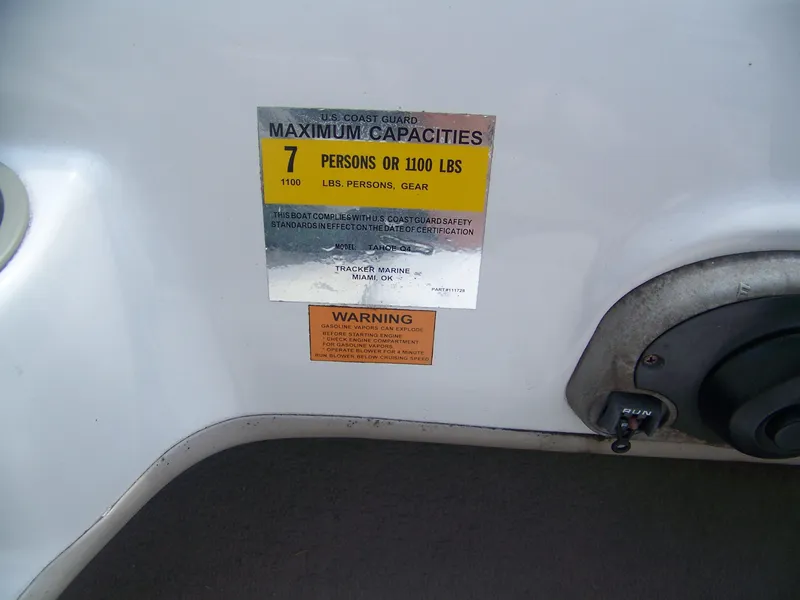 Slide: The Image of Sticker on 2004 Tracker Q4 boat showing maximum capacity and safety warnings. - 5