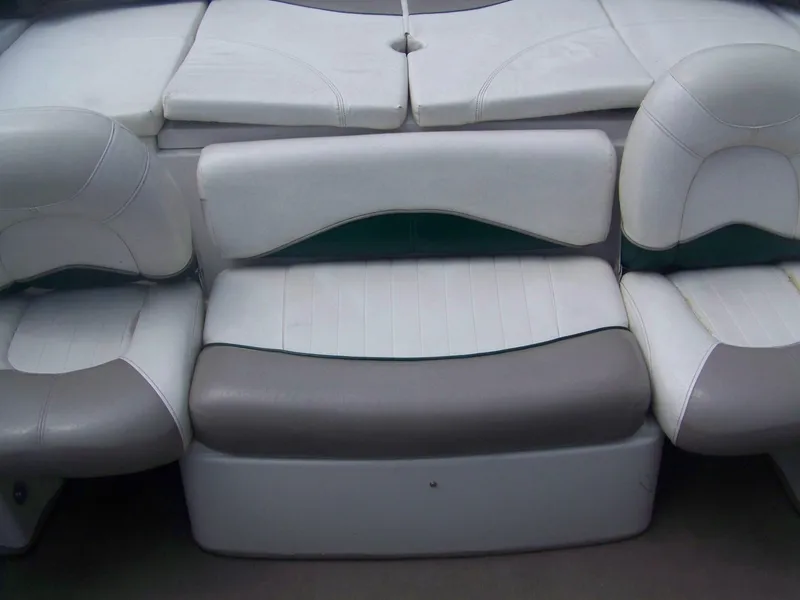 Slide: The Image of 2004 Tracker Q4 boat seating with white and gray upholstery. - 6