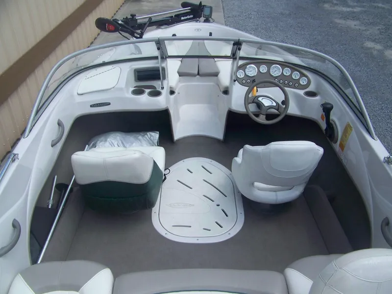 Slide: The Image of 2004 Tracker Q4 boat interior with steering wheel, seats, and dashboard gauges. - 8