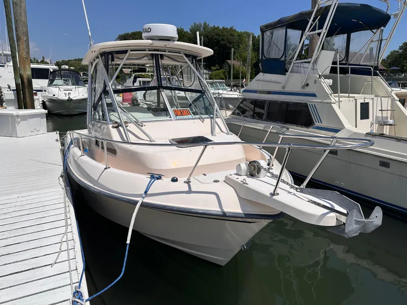 Slide: The Image of 2004 Grady-White Gulfstream 232 boat docked, for sale sign visible. - 1